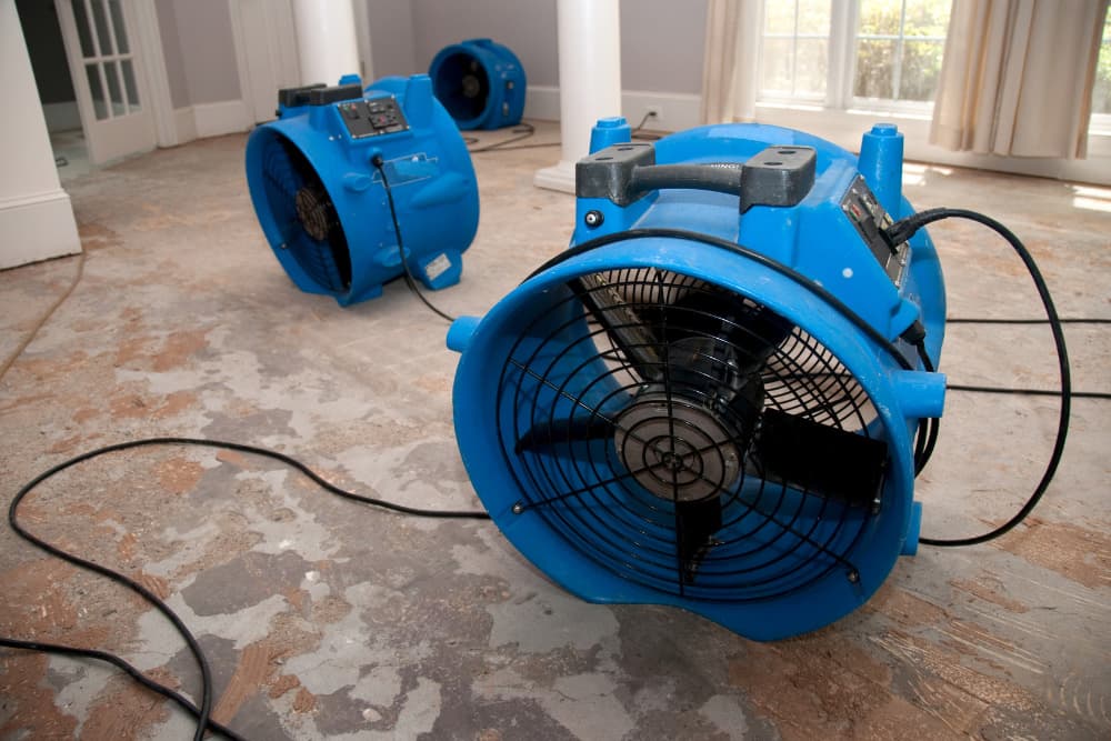 A wood floor being dried by multiple units as part of Bloomington flood cleanup emergency services.