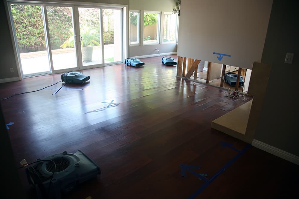A wood floor being dried by multiple units as part of Colton flood cleanup and restoration services.